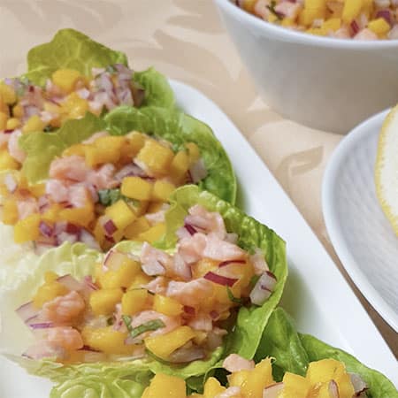 Ceviche de salmón y mango sobre cogollos de lechuga